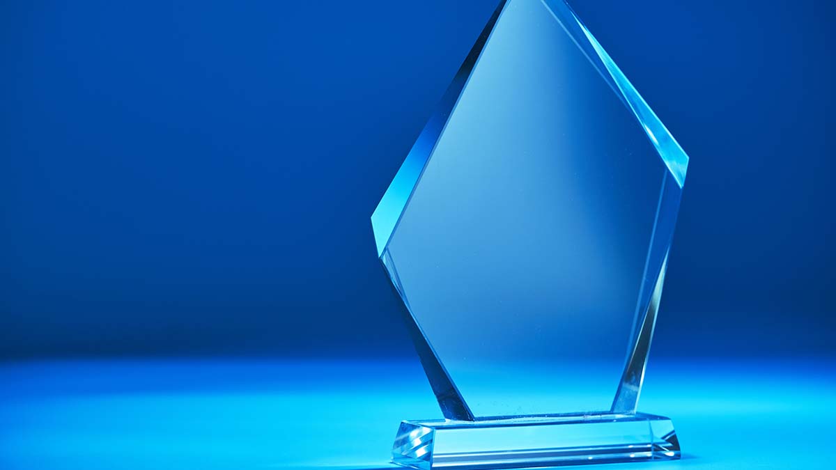 Awards | Crystal trophy against blue backgroound